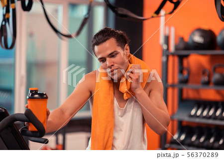 Nice handsome man taking a break in the workout Nice handsome man taking a break in the workout 56370289