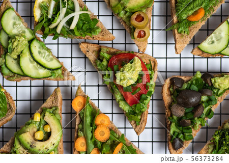 Vegetarian sandwiches with guacamole and Vegetarian sandwiches with guacamole and 56373284