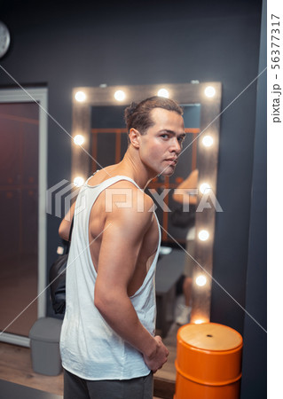 Pleasant handsome man wanting to change clothes 56377317