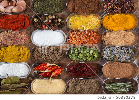 different spices in small containers 56380278