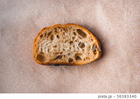 Slice of white bread on paper. 56383340