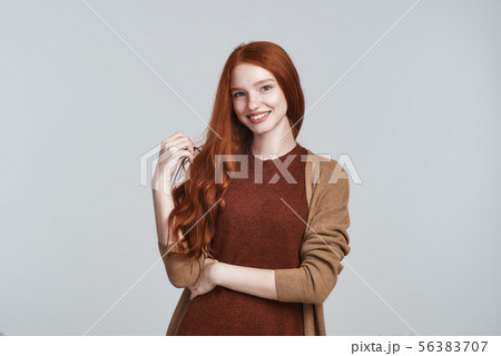 Natural beauty. Portrait of cheerful and cute young redhead lady in casual clothing smiling at Natural beauty. Portrait of cheerful and cute young redhead lady in casual clothing smiling at 56383707