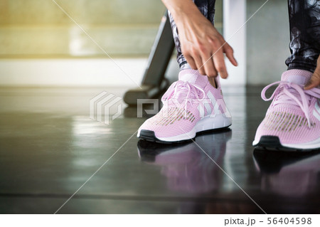 Close up women hand tying running shoe in gym 56404598