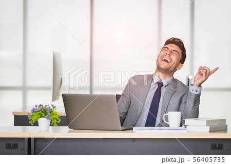 Caucasian businessman laughing in office.. 56405735