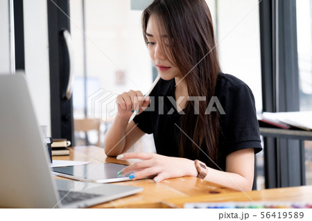 Graphic designer working at her desk in creative Graphic designer working at her desk in creative 56419589