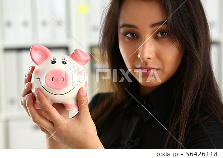 woman hold piggybank in arms woman hold piggybank in arms 56426118