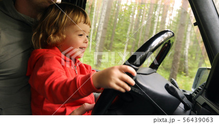 Happy little kid driving car with father Happy little kid driving car with father 56439063