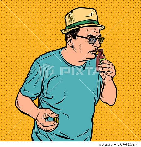 a man sniffs a bottle. perfume or medicine 56441527