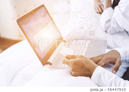 Husband hand holding a credit card and using a Husband hand holding a credit card and using a 56447910