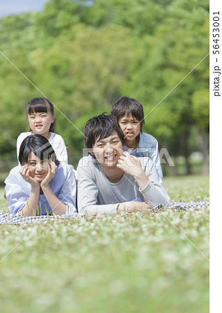 芝生に寝転ぶ4人家族 芝生に寝転ぶ4人家族 56453001