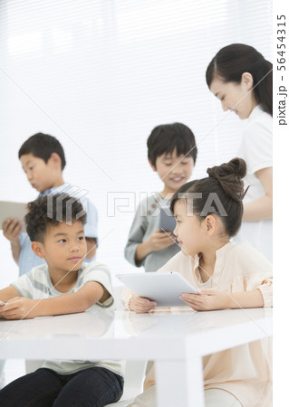 タブレットPCで勉強する小学生と先生 タブレットPCで勉強する小学生と先生 56454315