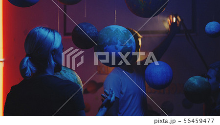 Teacher explaining astronomy to students 56459477