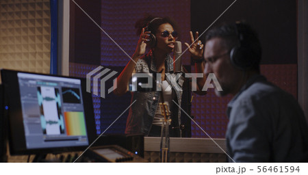 Vocalist and sound engineer working in studio Vocalist and sound engineer working in studio 56461594