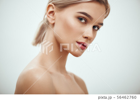 Feeling beautiful. Gorgeous young blonde woman with perfect skin looking at camera while standing 56462760