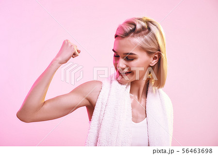 You are stronger than you think Attractive young sporty woman showing her bicep and smiling while You are stronger than you think Attractive young sporty woman showing her bicep and smiling while 56463698