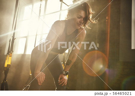Just a minute to rest. Young athletic woman in sportswear looking exhausted while standing at gym 56465021