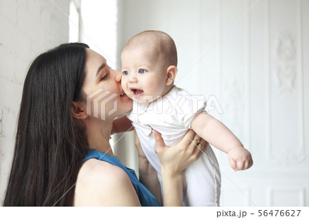 Mother holding sweet baby boy Mother holding sweet baby boy 56476627