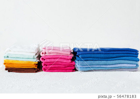 Pile of colorful textile swatches on white 56478183
