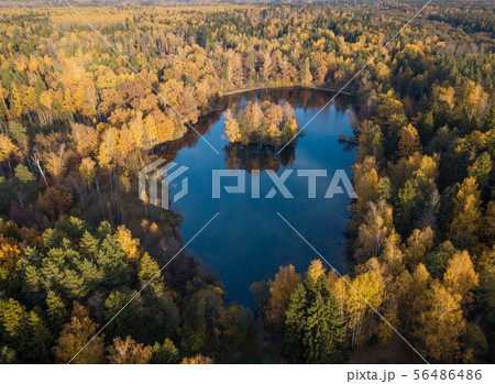Aerial view of the blue crystal-clear lake and lonely island in the middle of it hidden and Aerial view of the blue crystal-clear lake and lonely island in the middle of it hidden and 56486486