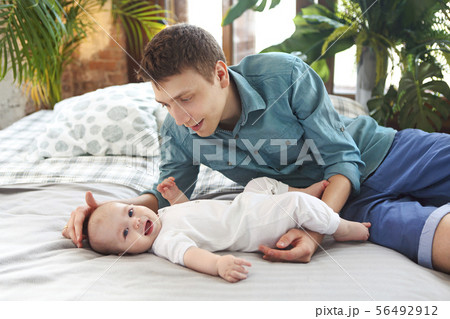 Happy young father holding baby boy 56492912