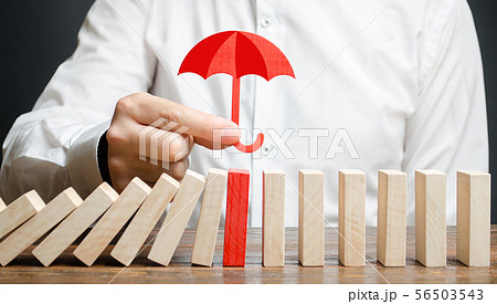 A businessman insures red dominoes 56503543