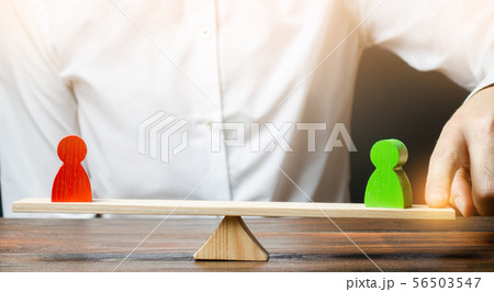 A person changes the balance of scales in favor  56503547