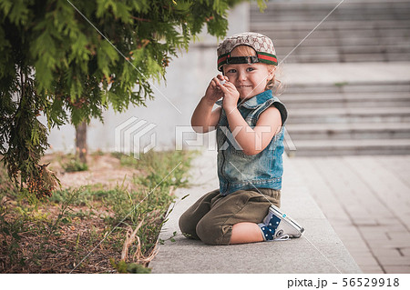 Cute little boy at summer day playing and smiling Cute little boy at summer day playing and smiling 56529918