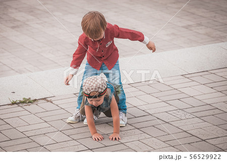 Cute little brothers at summer day playing and smiling Cute little brothers at summer day playing and smiling 56529922