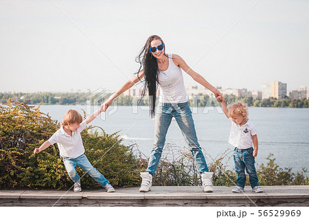 Happy family. Young mother and her five year old son spending time outdoor on a summer day Happy family. Young mother and her five year old son spending time outdoor on a summer day 56529969