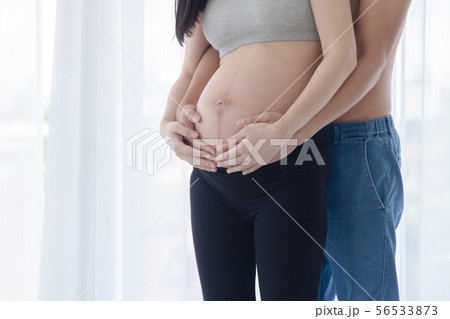 Husband hug pregnant woman 56533873