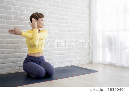 Asian woman doing yoga at home or studio Asian woman doing yoga at home or studio 56540404