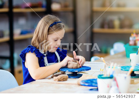 Child at pottery wheel. Kids arts and crafts class Child at pottery wheel. Kids arts and crafts class 56542937