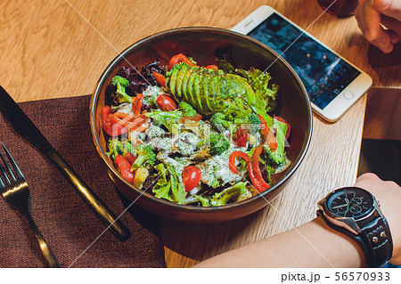 Vegetable salad with avocado, cucumber, cherry tomato, chard leaves and broccoli on a plate, on the Vegetable salad with avocado, cucumber, cherry tomato, chard leaves and broccoli on a plate, on the 56570933