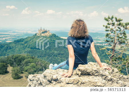 Young woman looks at Hohenzollern Castle, Germany 56571313