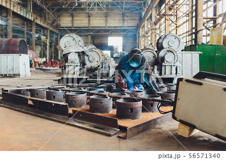 man factory interior, worker and cnc machine. 56571340