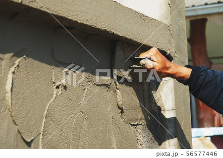 hand of worker plastering cement on wall 56577446