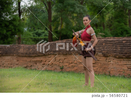 A beautiful girl in a red dress holding a sword. A beautiful girl in a red dress holding a sword. 56580721