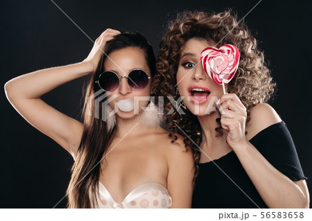 Two different girls looking at camera and posing 56583658