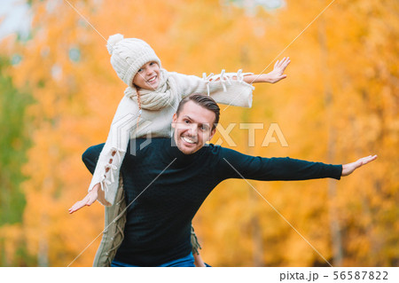 Family of dad and kid on beautiful autumn day in the park 56587822