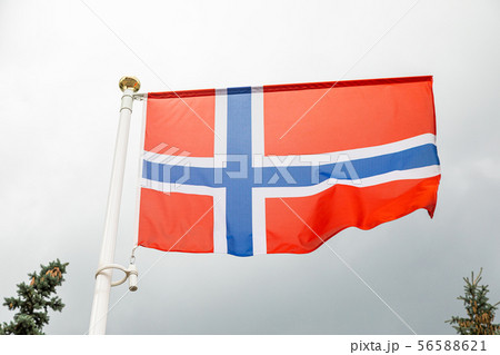 flag of Norway on a flagstuff in front of the sky flag of Norway on a flagstuff in front of the sky 56588621