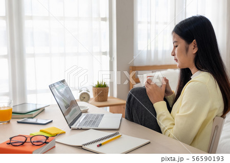 Asian female freelancer reading report on laptop Asian female freelancer reading report on laptop 56590193