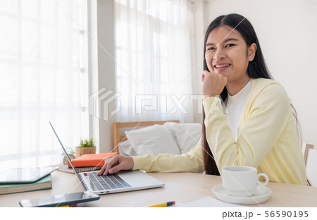 Asian female freelancer reading report on laptop Asian female freelancer reading report on laptop 56590195