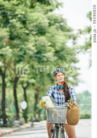 Positive woman enjoying bicycle ride Positive woman enjoying bicycle ride 56590830