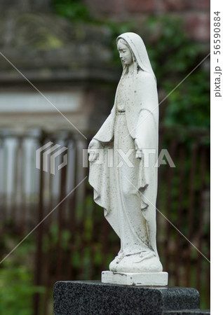 Closeup of stoned Virgin Mary. on tomb in cemetery 56590884
