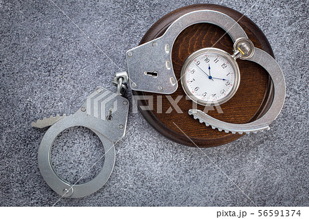 Open handcuffs with pocket watch Open handcuffs with pocket watch 56591374
