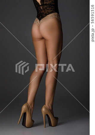 slim sexy female legs wearing high heels 56591516