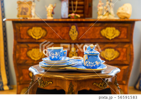 Set of ancient tableware on wooden table in museum 56591583