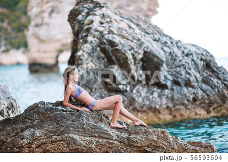 Cute little girl at beach during summer vacation Cute little girl at beach during summer vacation 56593604