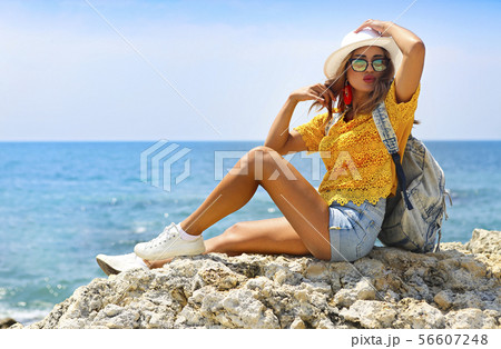Female tourist wanderlust with backpack wearing Female tourist wanderlust with backpack wearing 56607248