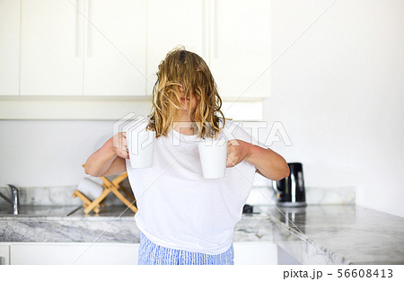 Woman with two cups of coffee in morning Woman with two cups of coffee in morning 56608413